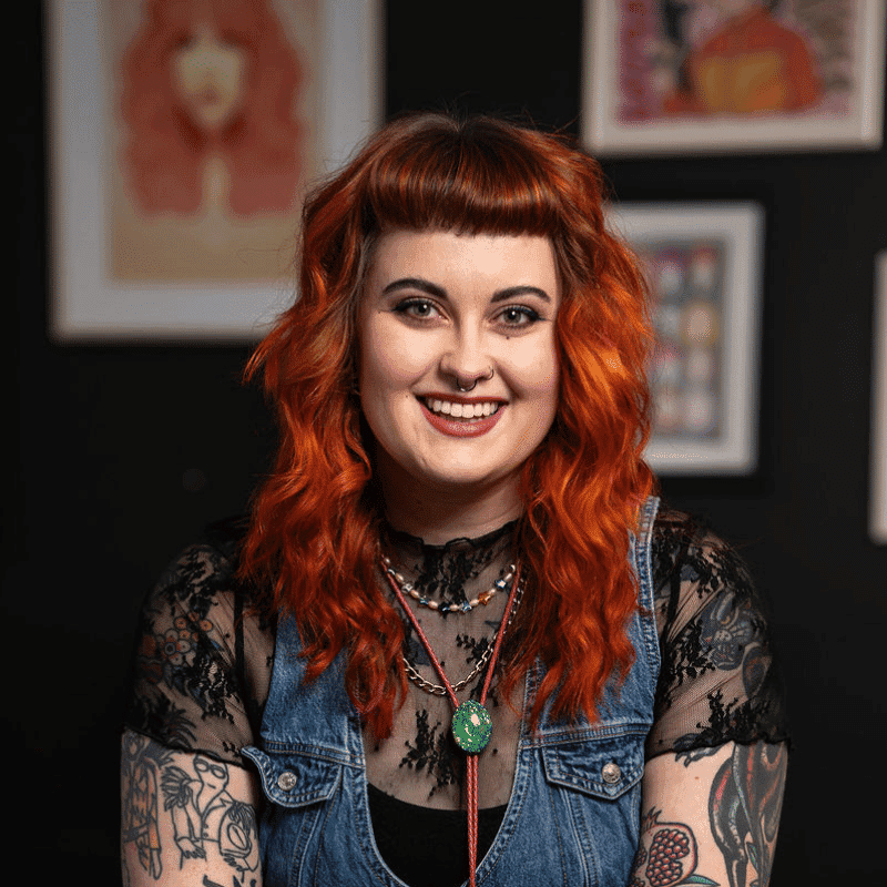 Portrait of Mya (She/They), a professional stylist at Rebel Hair, showcasing their expertise and style.